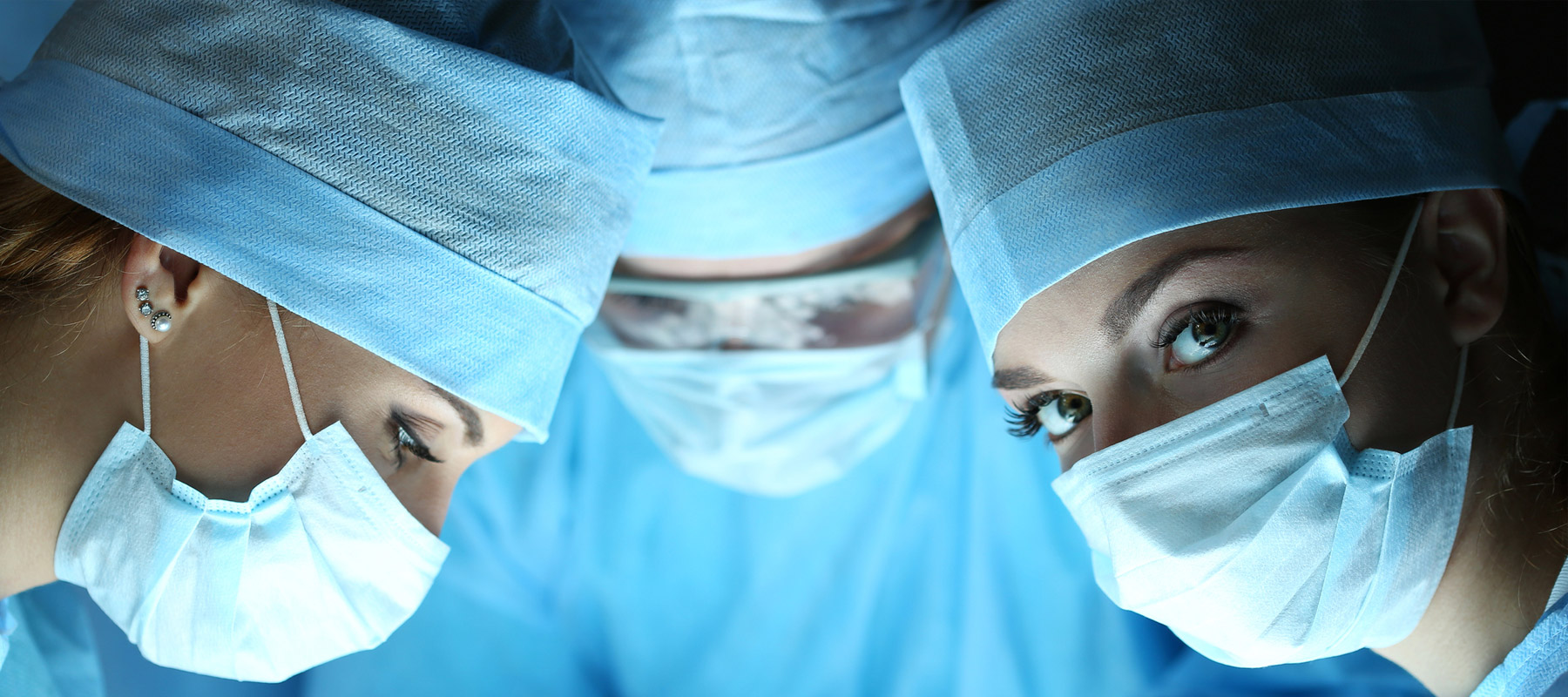 A masked nurse in a surgical room looks confidently at the camera. Northeastern prepares our nursing degree students for any career in the field.