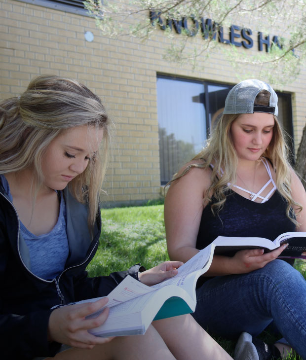 Students studying on the lawn of the Monahan Learning Center at Northeastern Junior College. Students can expect to receive free tutoring at the MLC, as well as many other services to help along their educational journey at NJC.
