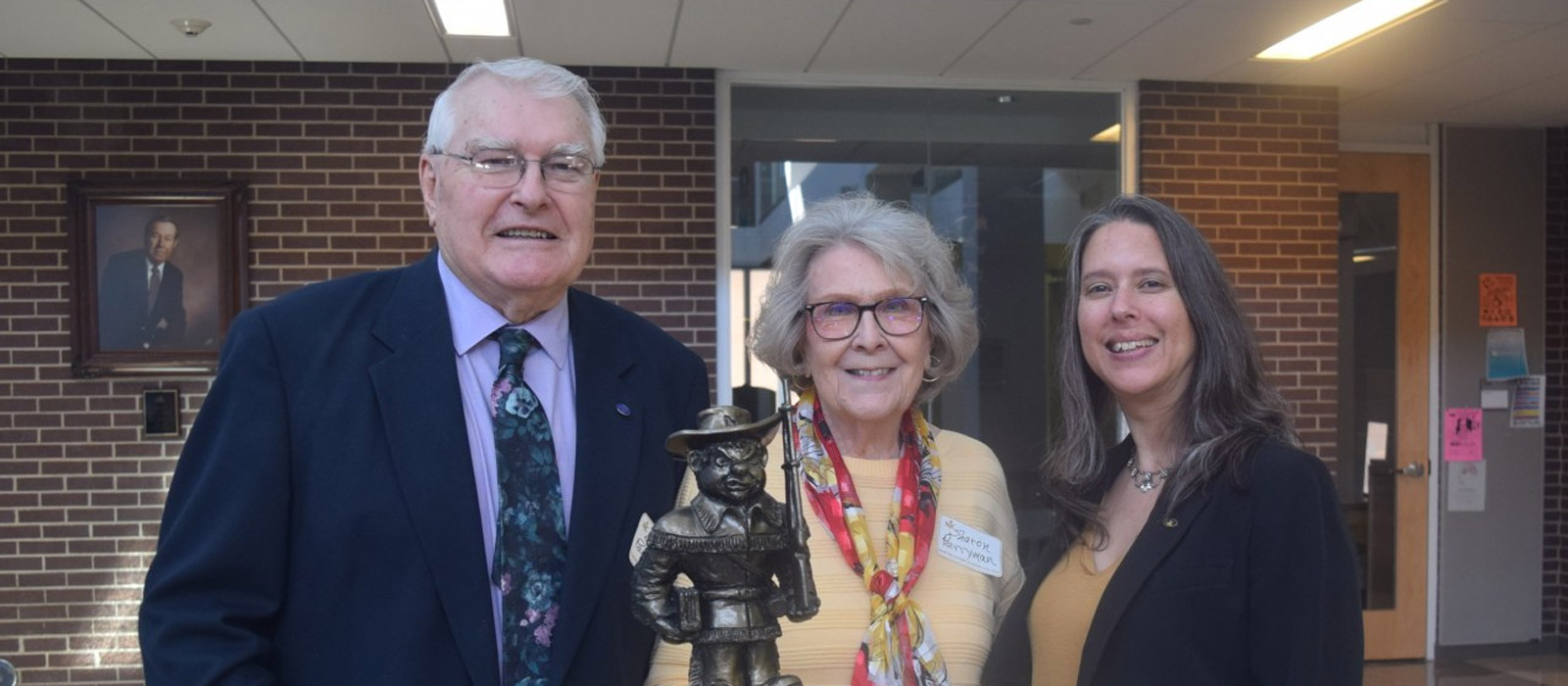 Dr. Bruce Perryman, President’s Award recipient, and wife, Sharon, presented an NJC Plainsman bronze desktop sculpture made by local artist Bradford Rhea to NJC Alumni Association Executive Director Heather Brungardt at the Hoops Homecoming Awards Luncheon Saturday, Feb. 19, 2022. Early on in his presidency at NJC, Perryman commissioned Rhea to create the sculpture and it has since resided in his office for many years.