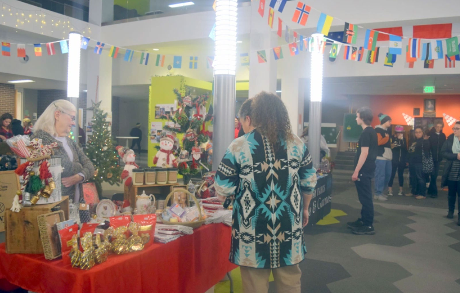 Guests browse the various booths featuring festive decorations and food from around the world at Northeastern Junior College’s Hanging of the Greens celebration Tuesday, Nov. 29, 2022