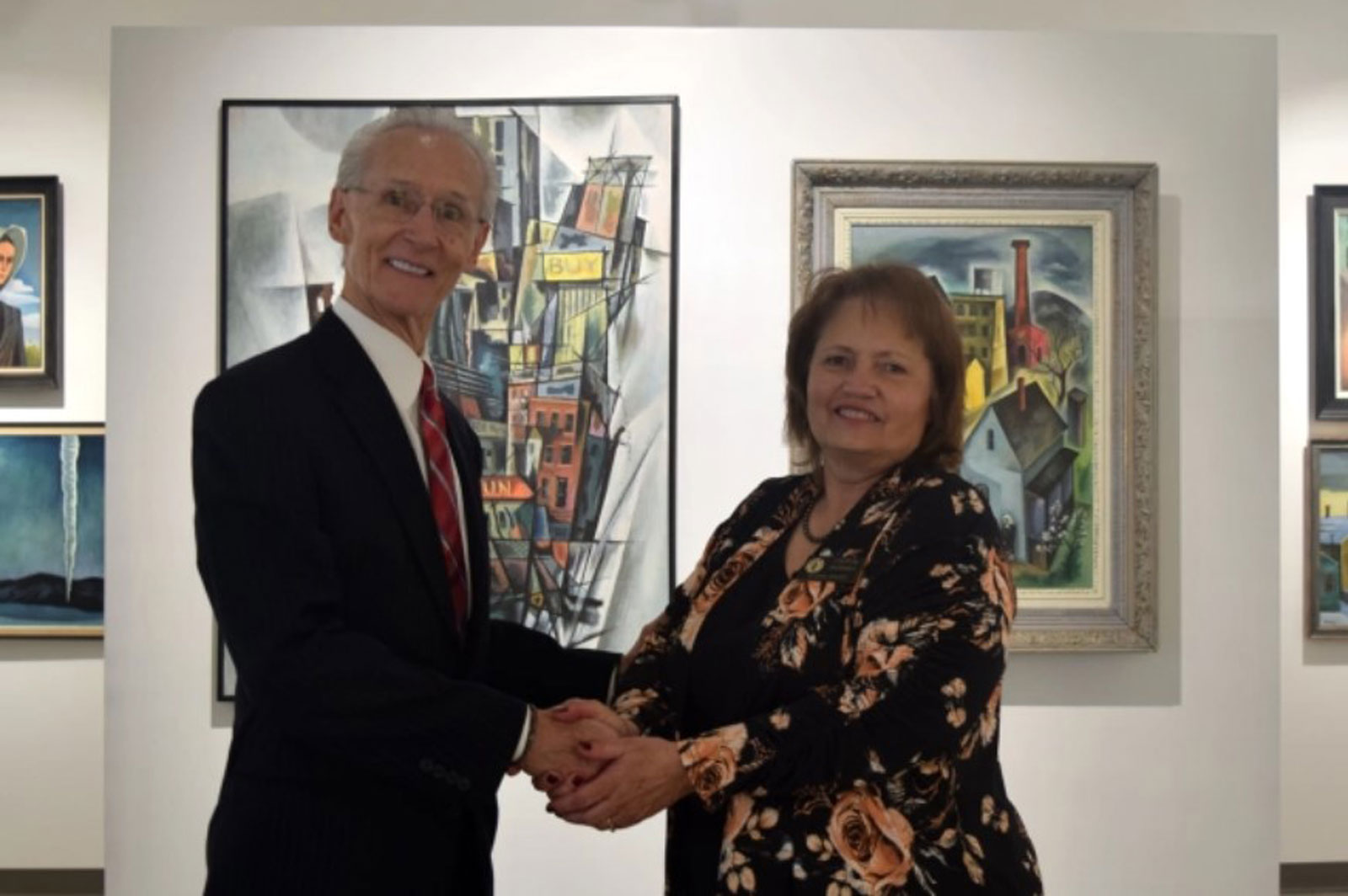 Ken Shaw, the winner of Northeastern Junior College Alumni Association’s Pathfinder Award, is congratulated by board secretary Laural Brownell during the association’s awards luncheon Saturday, Feb. 4, 2023. 