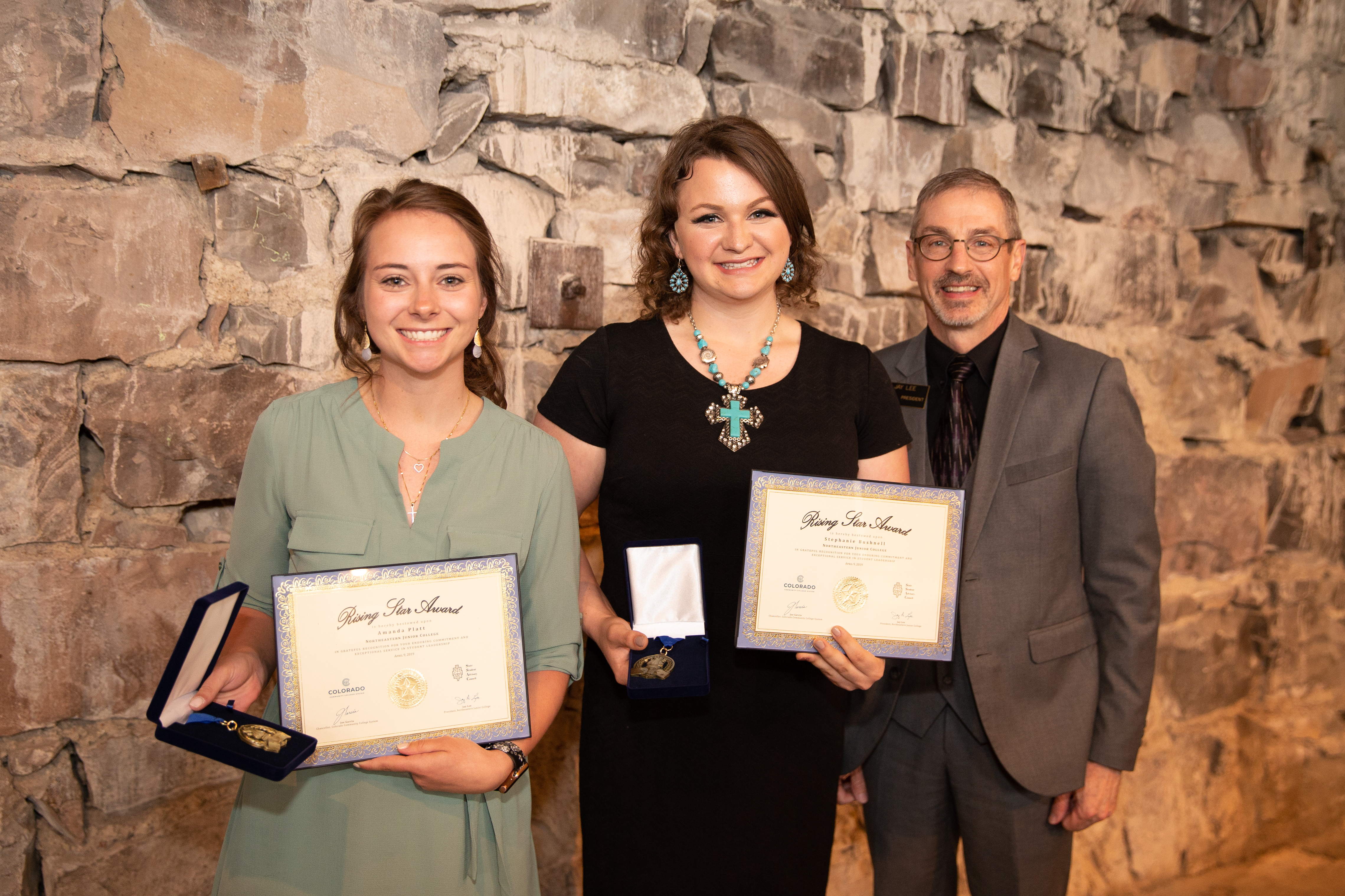 Pictured left to right, Amanda Platt, Stephanie Bushnell, Northeastern President Jay Lee