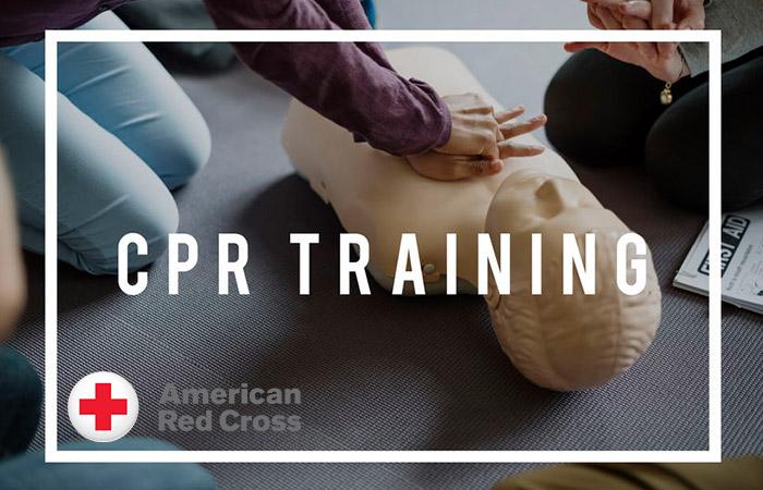 Image of a person practicing chest compressions with CPR written over the image.  