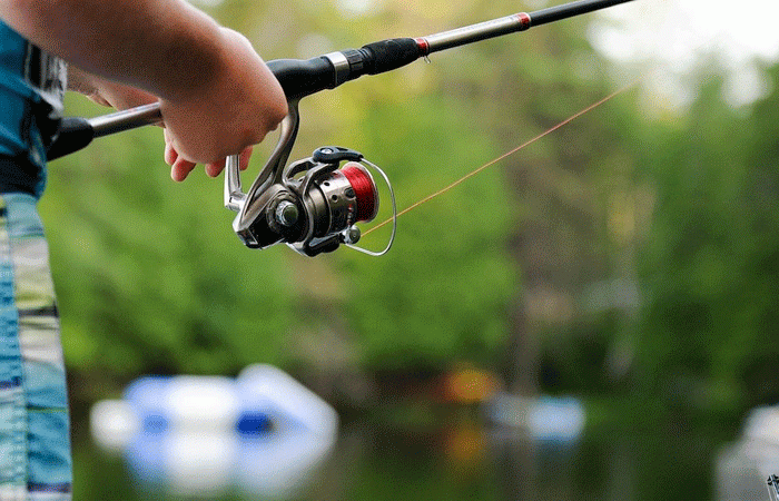 kid holding a fishing pole 