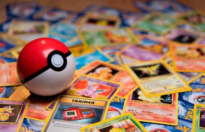 Pokémon ball laying on Pokémon cards