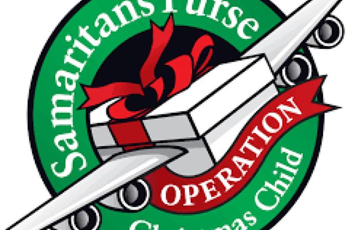 says: Samaritan's Purse Operation Christmas child. Circled in green with red banner and an white airplane made of a shoebox e 