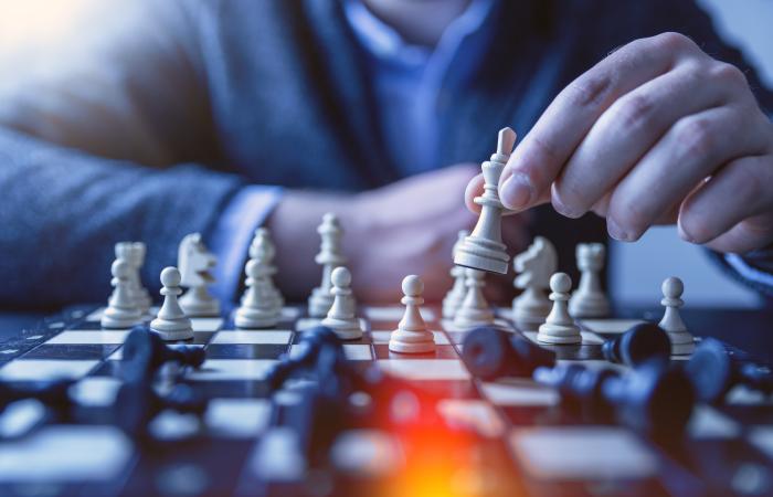a person making a chess move