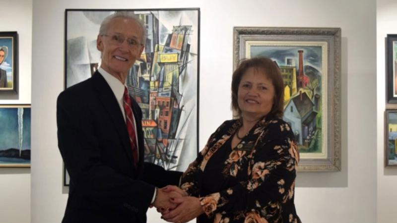 Ken Shaw, the winner of Northeastern Junior College Alumni Association’s Pathfinder Award, is congratulated by board secretary Laural Brownell during the association’s awards luncheon Saturday, Feb. 4, 2023