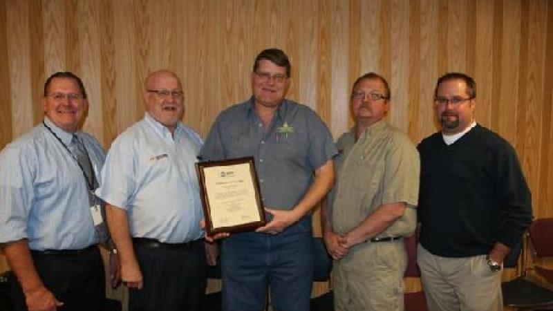 Layton Peterman, head of the automotive technology program at NJC (center, holding plaque) is flanked by some members of the college s automotive program advisory committee who helped oversee the ASE accreditation process including, (from left) Wally Beardsley from RE1 Valley School district, Tim Richie from NAPA Auto and Truck Parts, Peterman, Arlin Dressel of ALD Automotive (Yuma) and Mike Schadegg of Wolf Auto. 