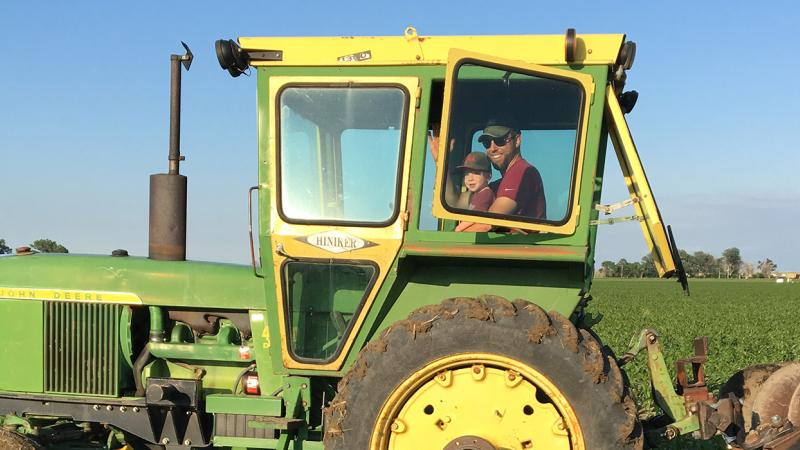 Andy Bartlett and son in a tractor in a field