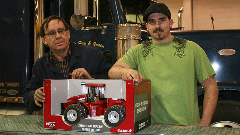 NJC diesel instructor Harv Rober (left) and Northeastern Diesel  Power Club President Cody Meyer of Cortez, CO (right) display the Steiger 480 Tractor Dealer Edition door prize that will be given away to a lucky winner during the Club’s toy show this Saturday at north campus. 