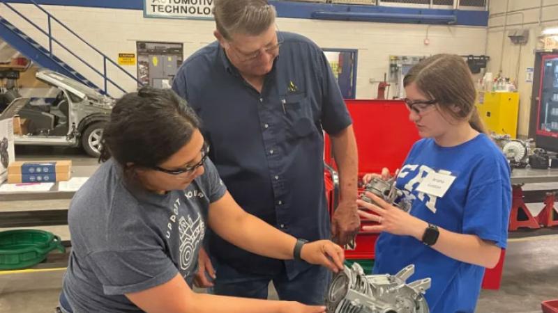 Ariana Gaston, right, and Leigha Henry, left, work with NJC Instructor Layton Peterman, center, on rebuilding their small engine during the engine fundamentals training for high school agriculture instructors at Northeastern Junior College Applied Technology Campus. 