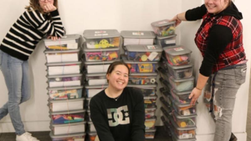 Northeastern Junior College Phi Theta Kappa Honor Society students pose for a picture with some of the boxes they and others packed for Operation Christmas Child at a box packing party Tuesday, Nov. 15, 2022.