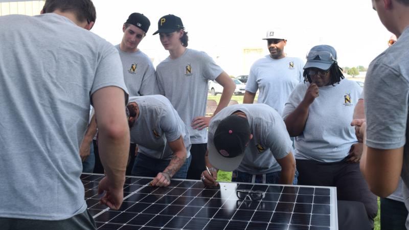 NJC Students signing solar panel 