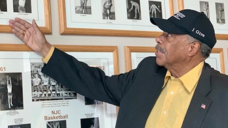Mayor Wellington Webb looks over some of his basketball pictures in Northeastern Junior College’s Heritage Center. During his time at NJC he established records playing as a power forward.