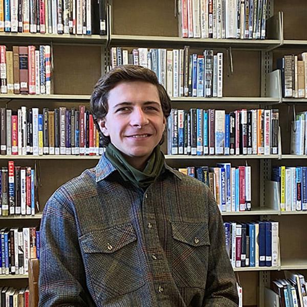 Alex sitting at in a library 