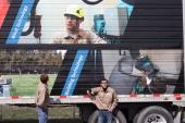 Wind turbine student looking at image of wind turbine student on trailer