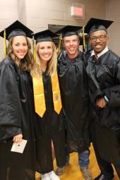 four students at graduation