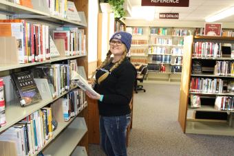 Student looking a new books in the library.