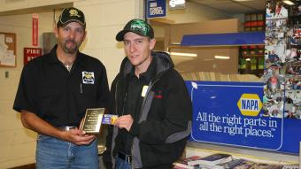 Aaron Hettinger, outside sales manager for NAPA (left), presents the NAPA Student of the Month award for September to Brendan Mahoney (right.)