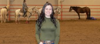 Image of Cora Johnson in the equine facility.